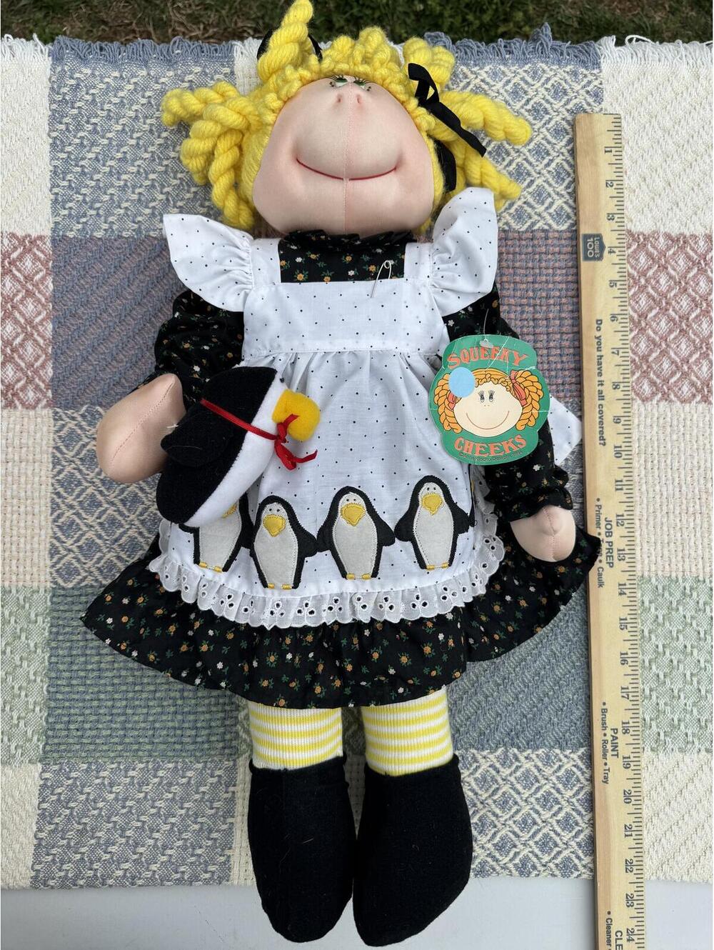 Vintage Squeeky Cheeks Doll with Yellow Yarn Hair and Penguin Apron